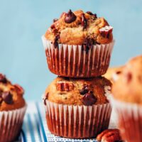 Stack of two banana chocolate pecan muffins