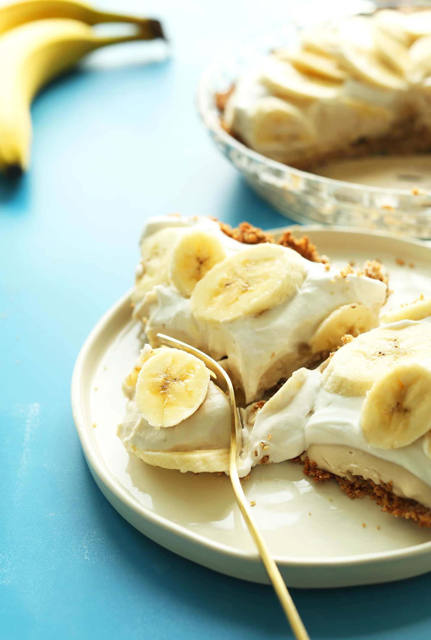 Using a fork to cut into a slice of our delicious Banana Cream PIe
