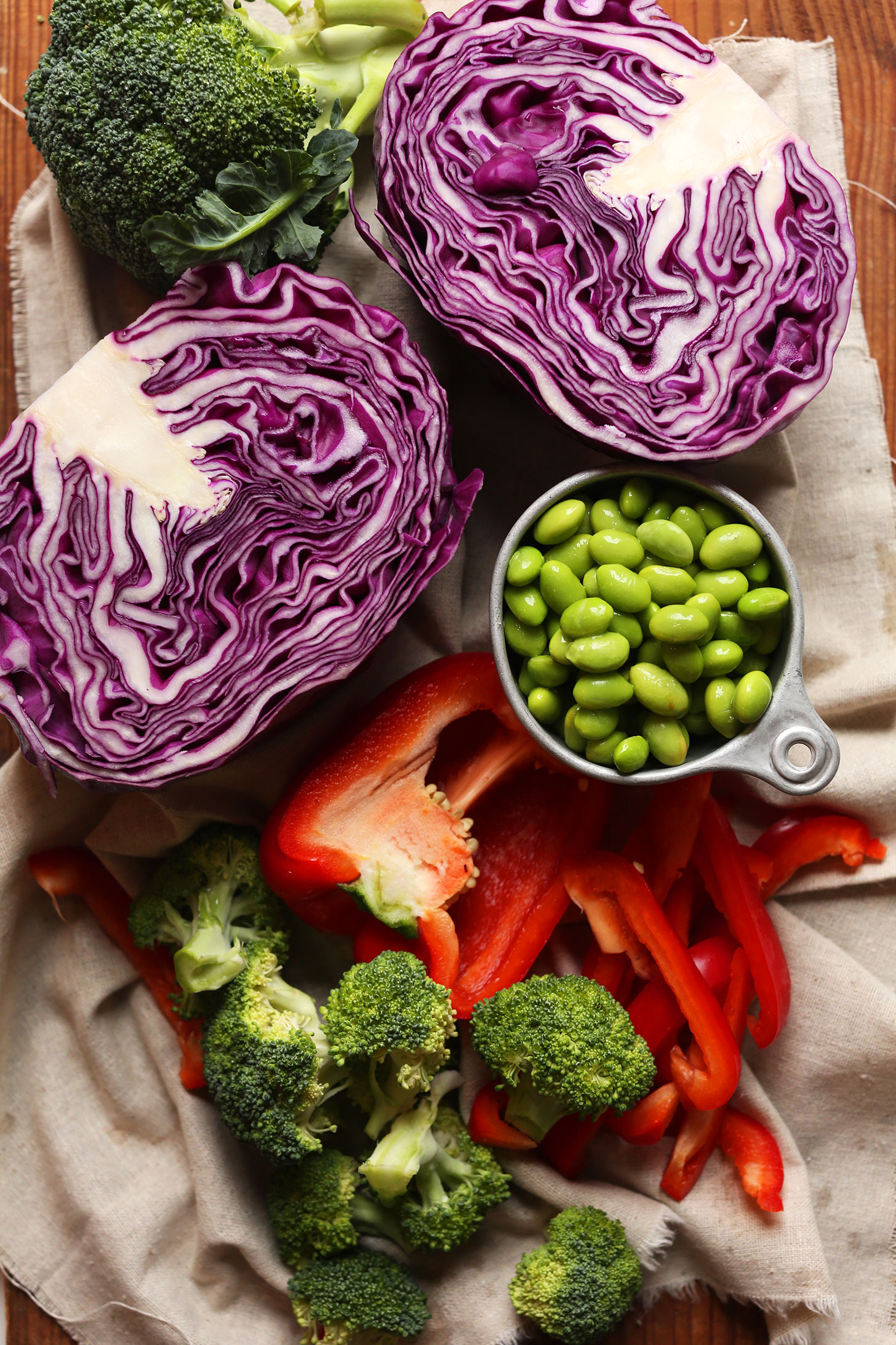 Towel with broccoli, bell pepper, edamame, and red cabbage for making our Vegan quinoa Salad recipe