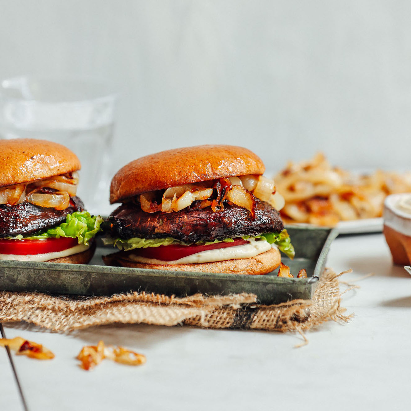 Tray of Balsamic Marinated Portobello Burgers topped with Caramelized Onions and Garlic Aioli
