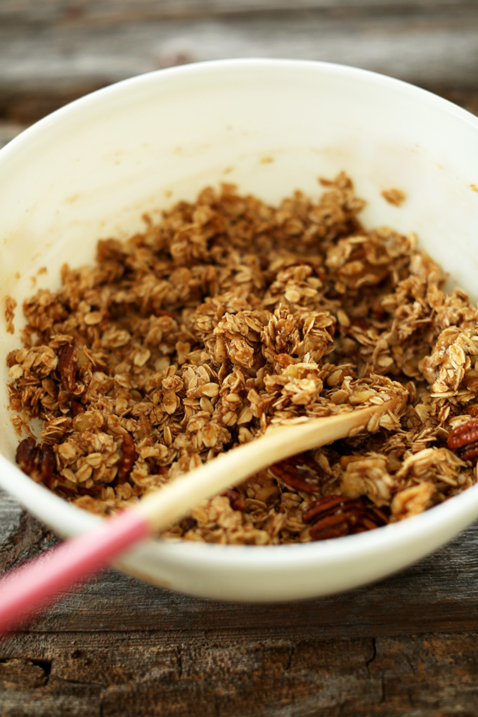 Stirring a bowl of our gluten-free vegan Banana Bread Granola recipe