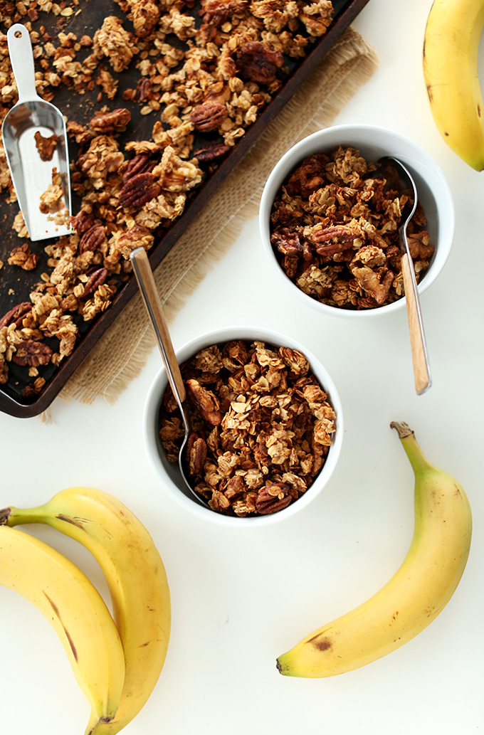 Baking sheet and bowls filled with Banana Bread Granola made with walnuts and flax