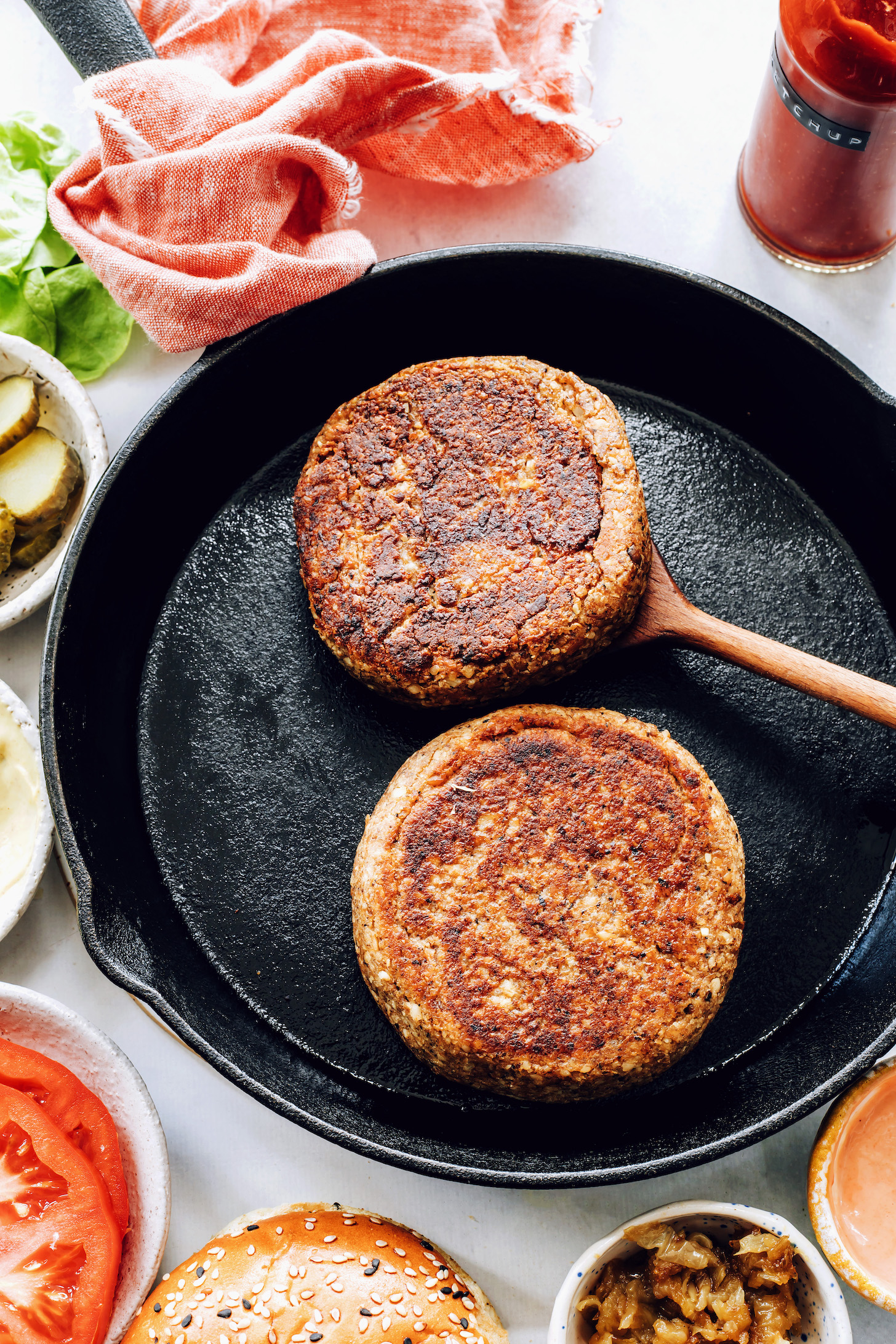 Cooking gluten-free vegan burger patties in a cast iron skillet
