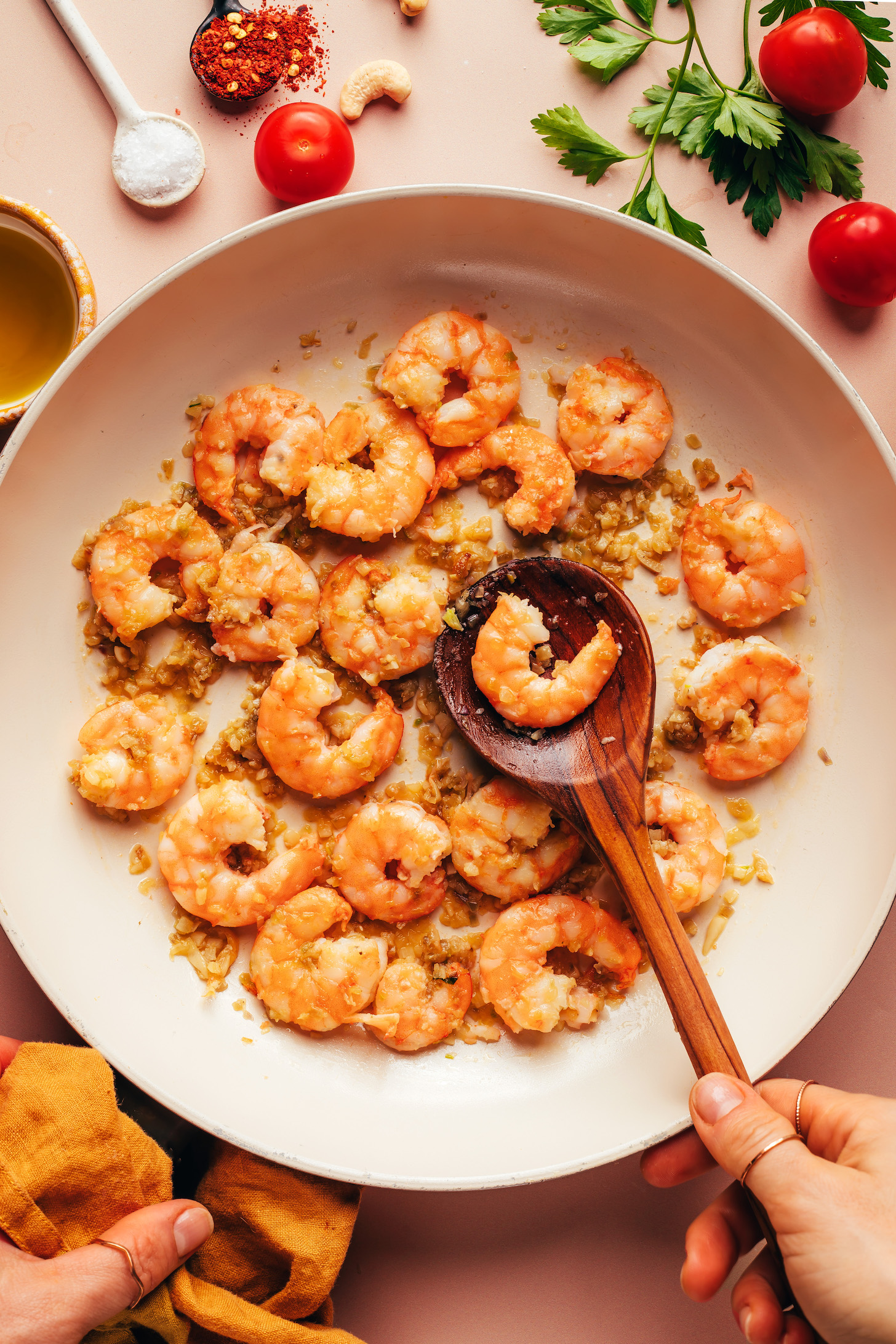 Cooked shrimp in a skillet with sautéed shallot and garlic