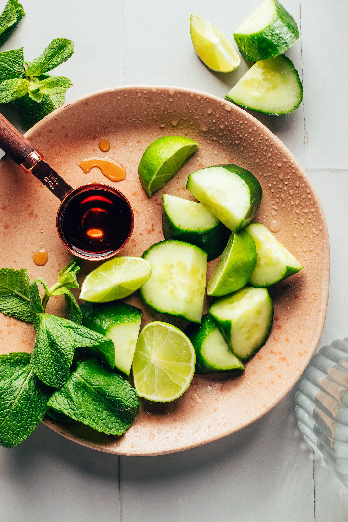 Fresh mint, maple syrup, lime wedges, and sliced cucumbers
