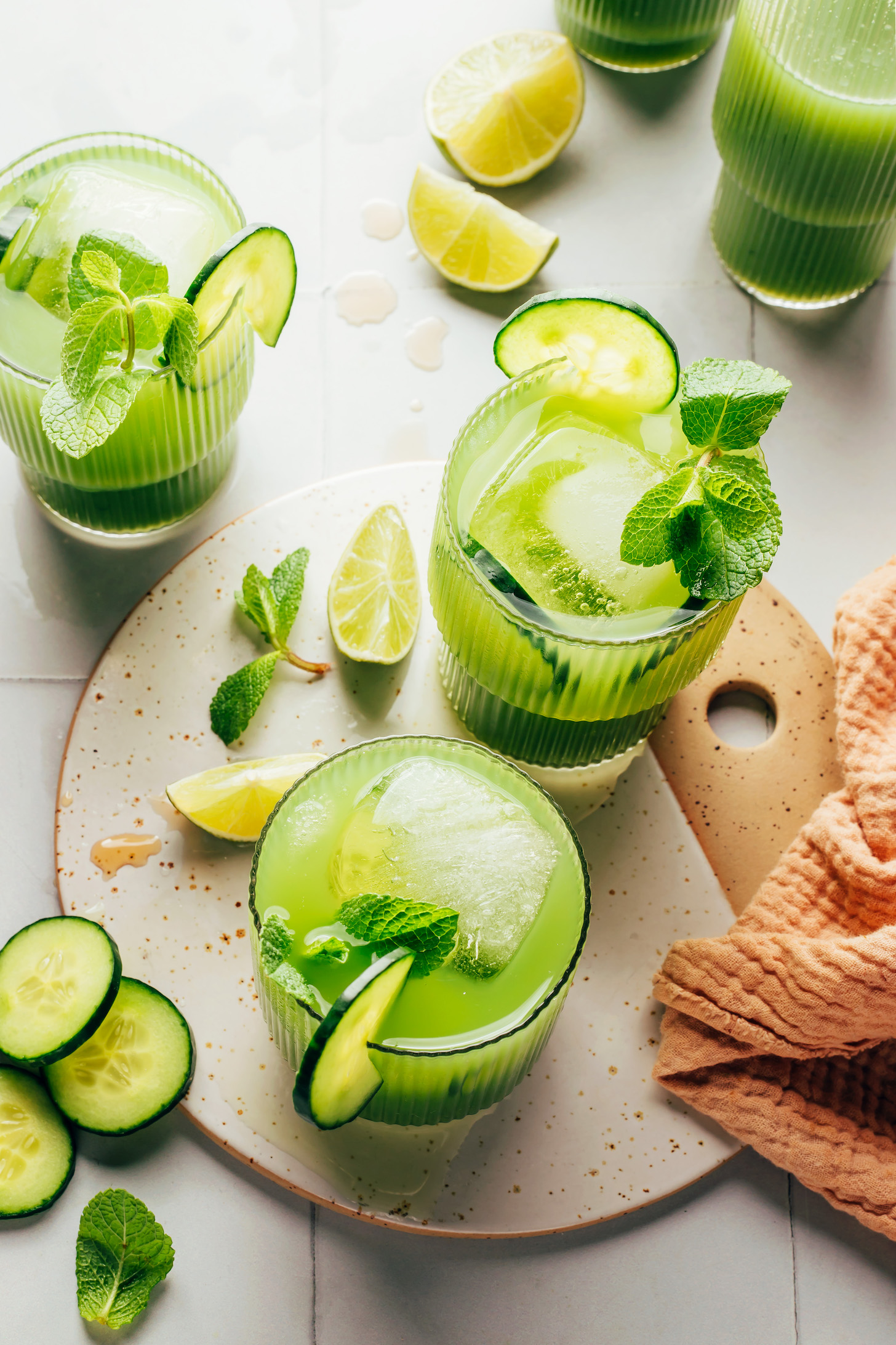 Overhead shot of several glasses filled with our cucumber lime agua fresca recipe