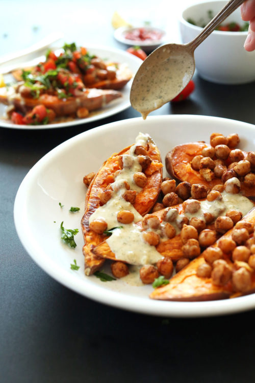 Drizzling dressing onto Mediterranean Baked Sweet Potatoes