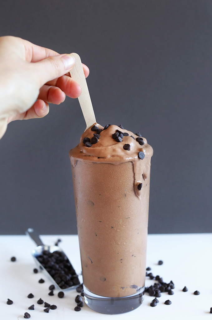 Using a mini wooden spoon to stir a vegan Double Chocolate Blizzard