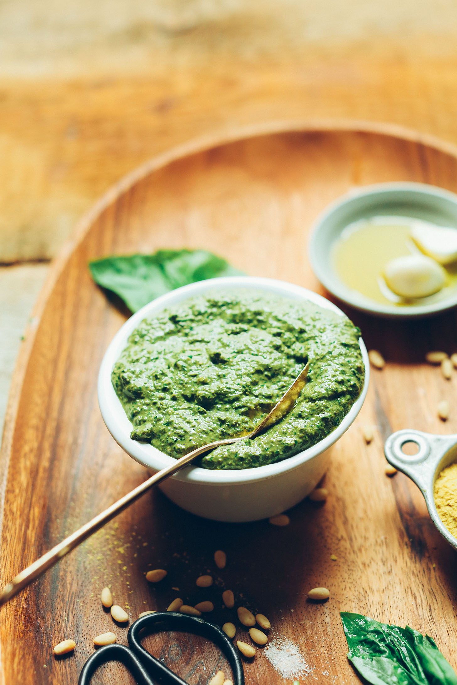 Bowl of easy homemade Vegan Pesto on a wood platter