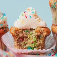 Close up photo showing the inside of a gluten-free funfetti cupcake