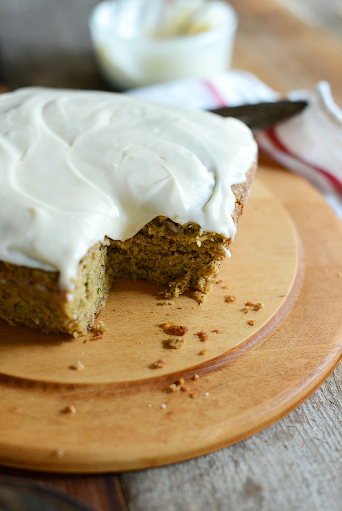 Loaf of Gluten-Free Zucchini cake topped with Dairy-Free Frosting