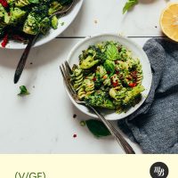 Bowls of our Roasted Broccoli Pasta Salad recipe beside ingredients used to make it