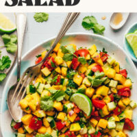 Overhead photo of a bowl of our Easy Mango Cucumber Salad recipe with text above that says ready in 15 minutes