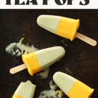 Homemade mango green tea popsicles on a dark background