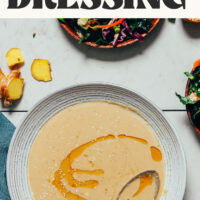 Bowl of Ginger Garlic Miso Tahini Dressing with text above it that says ready in 10 minutes