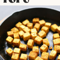 Cast iron skillet of our Quick + Easy Crispy Tofu with text above it that says ready in 25 minutes