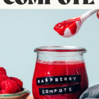 Holding a spoonful of our easy raspberry compote over a jar of more compote with text above that says naturally sweetened
