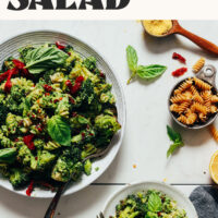 Large and small bowls of our Roasted Broccoli Pasta Salad with text above it that says made with hemp pesto