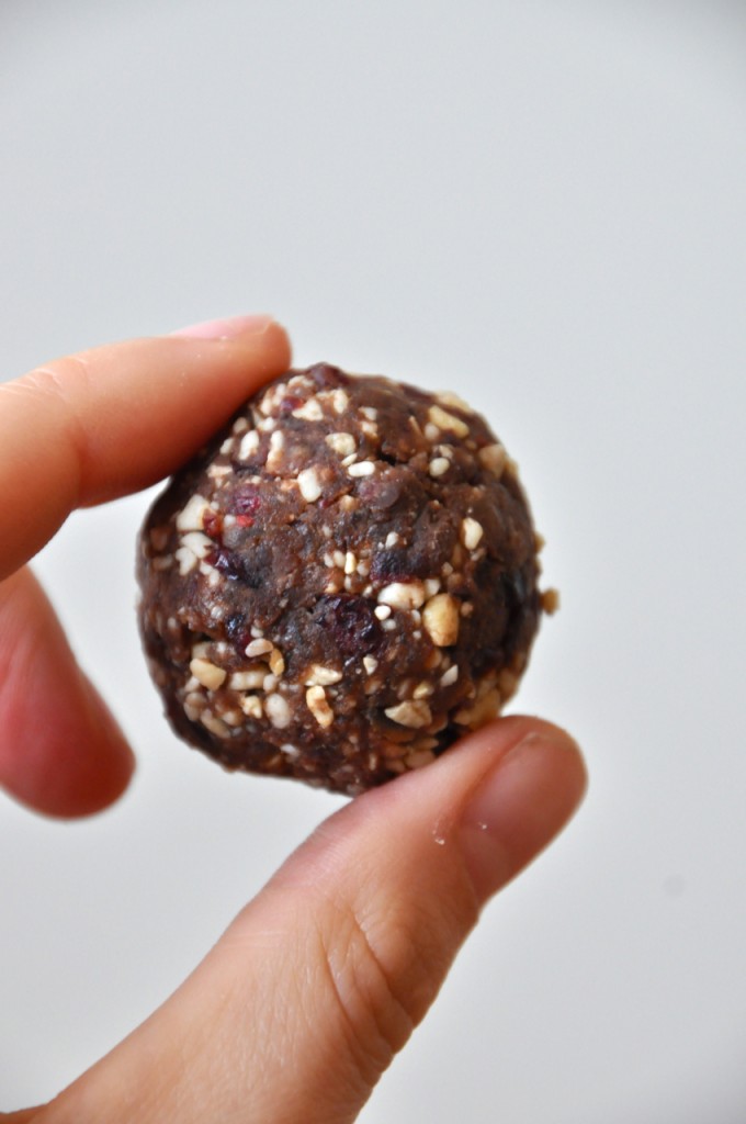 Holding up a bite of dough for our Chocolate Cashew Cookie Larabar Pops recipe