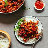 Plate of Moroccan Eggplant Tomato Stew with fresh parsley served over white rice