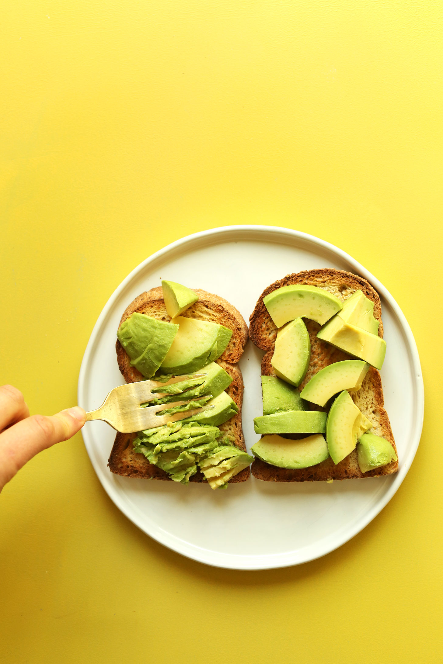Smashing avocado onto gluten-free toast