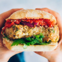 Close up shot of a Vegan Pizza Burger on a ciabatta bun with parsley and marinara