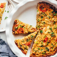 Partially sliced vegan tofu quiche in a pie pan