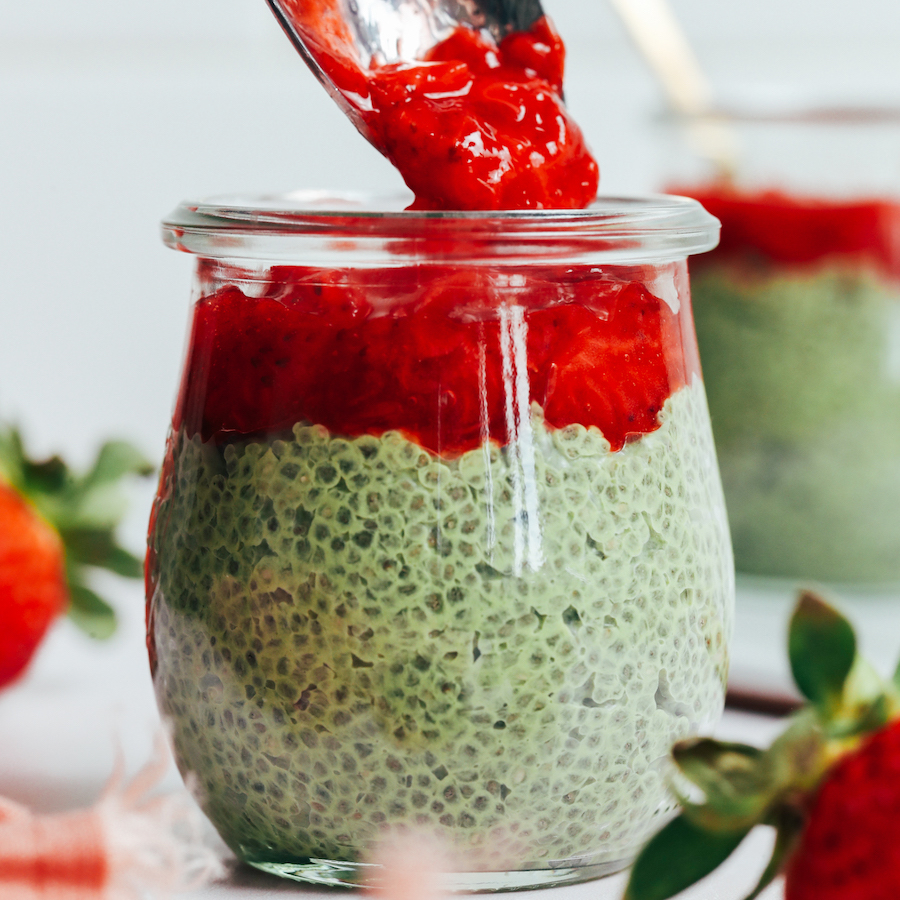 Adding strawberry compote over a creamy matcha chia pudding