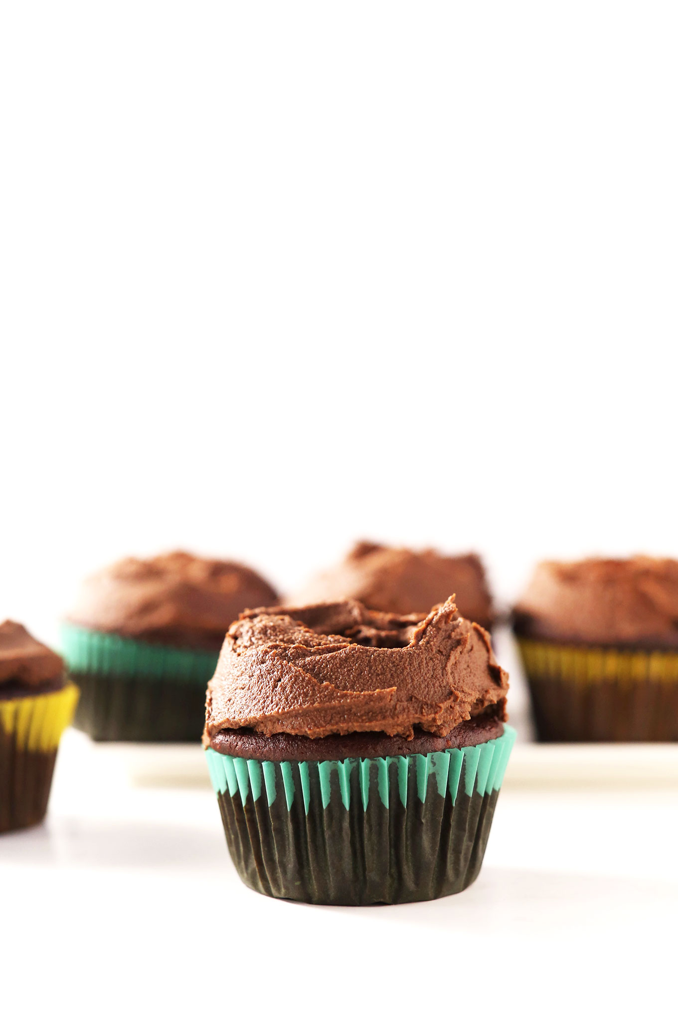 Close up shot of a chocolate cupcake topped with Vegan Chocolate Ganache Frosting