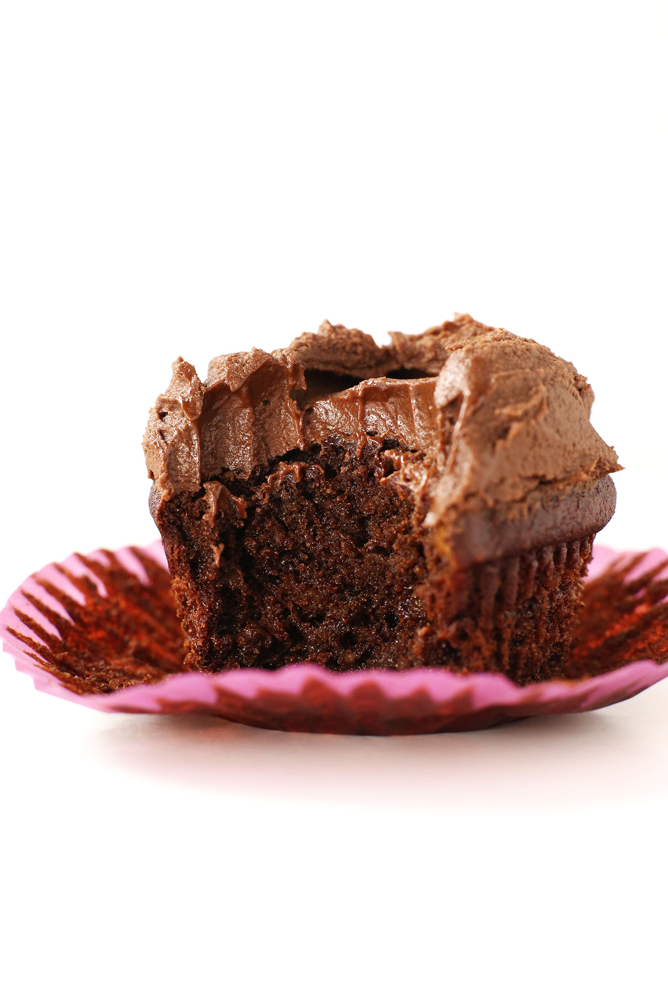 The Best Vegan Gluten-Free Chocolate Cupcake resting on a cupcake wrapper