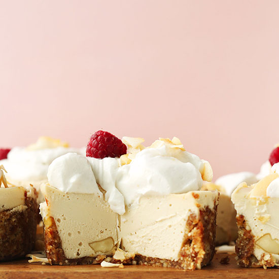 Cutting board filled with mini White Chocolate Macadamia Nut Cheesecakes